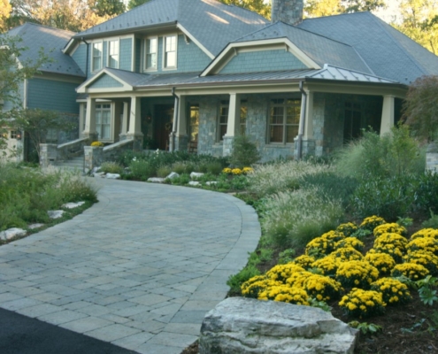 Stone Driveway with Perennial Foundation Plantings and Ornamental grasses